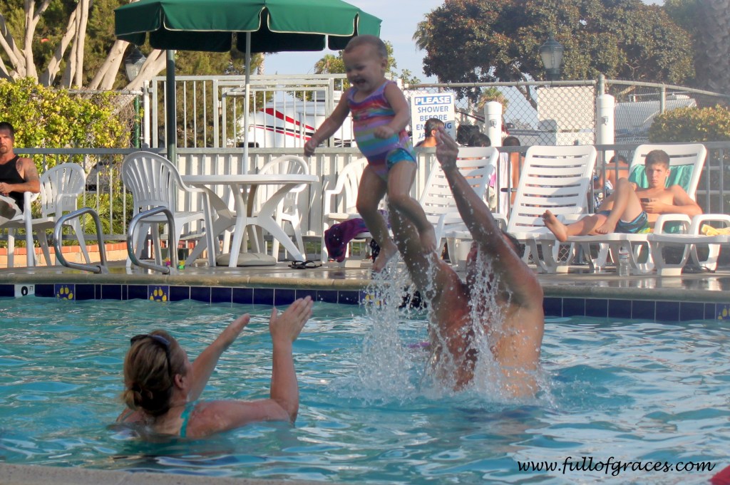 If you don't get in the pool, you can't hurl your one year old across the pool. But look at her face!